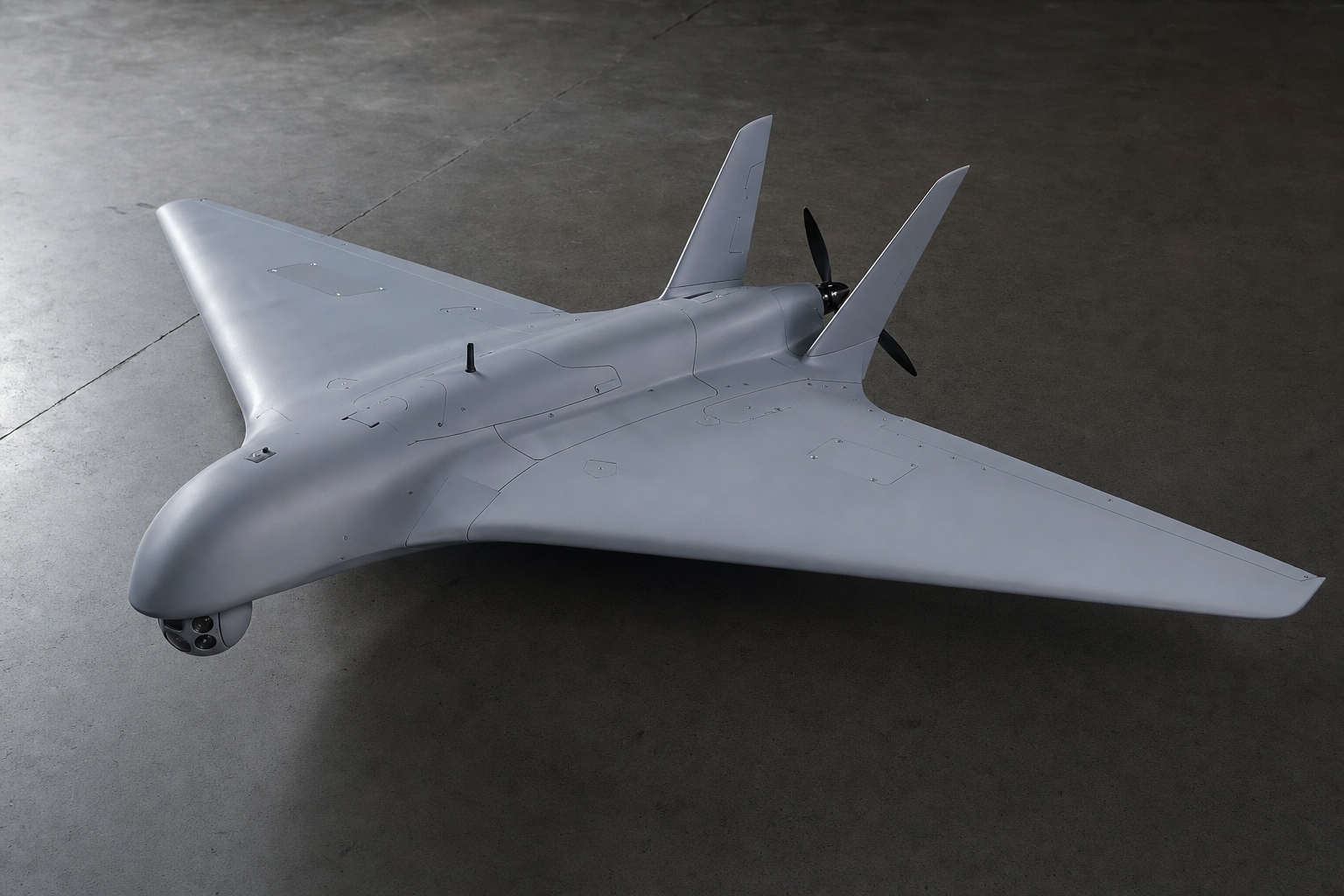 Long-endurance flying-wing reconnaissance drone with nose EO/IR sensor and pusher propeller